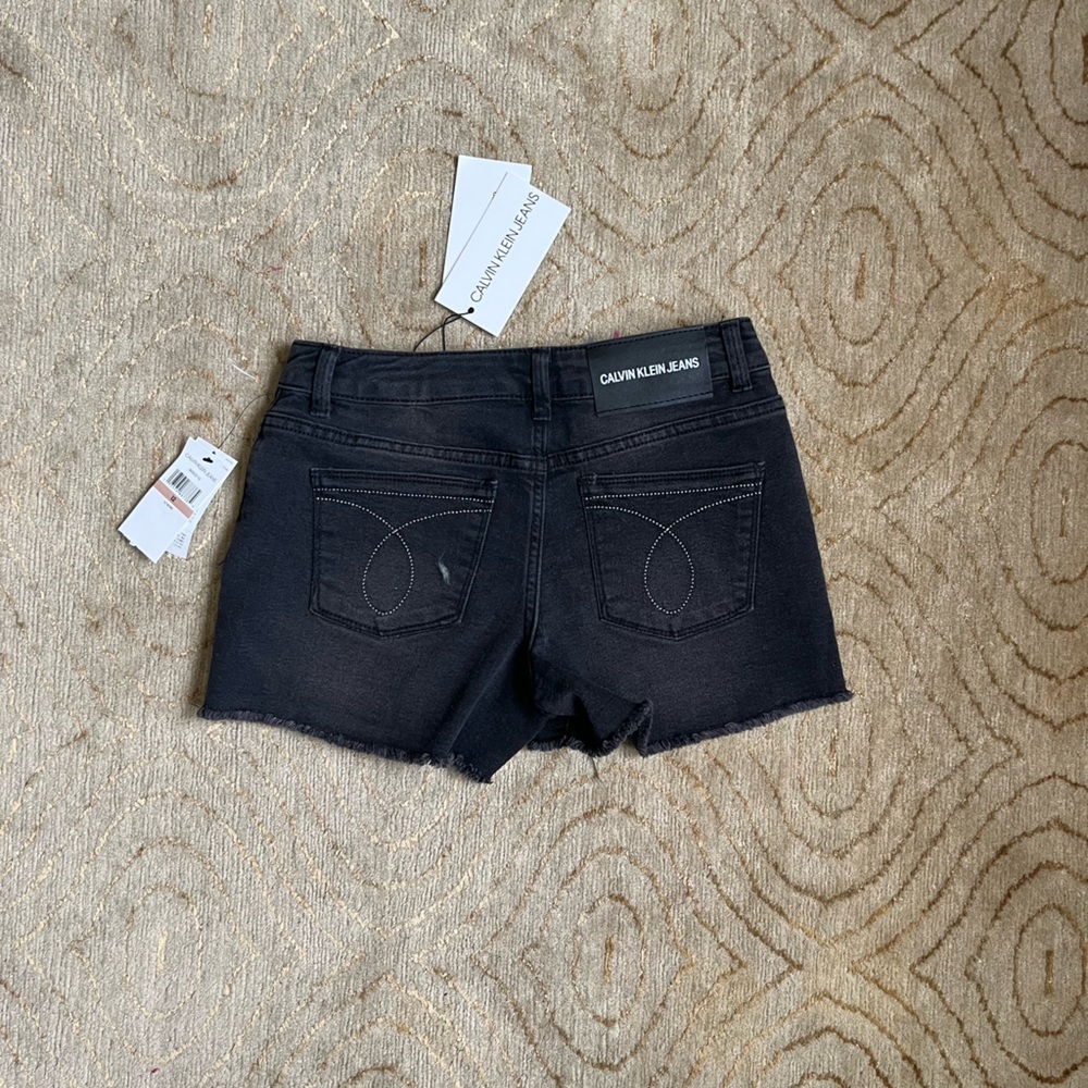 Calvin Klein Black Jean shorts mid-rise raw edge. Girl’s children size 12